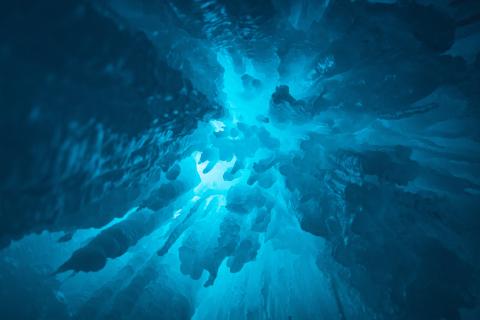 Underwater view looking up at spooky rock formations