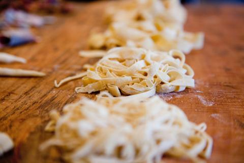 Fresh fettuccine resting in nests on a cutting board