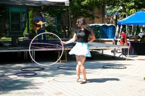 A young woman with a large hula hoop