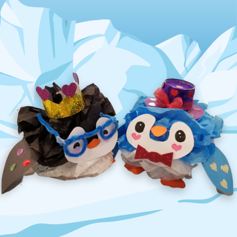 Two round tissue paper penguins in front of a cartoon iceberg