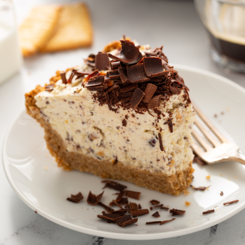 A slice of cannoli pie (graham cracker crust filled with cannoli filling and topped with chocolate)