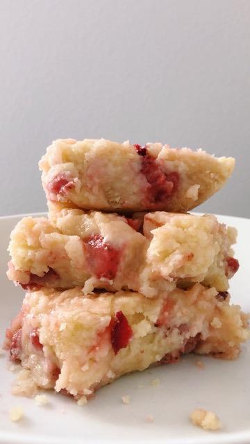 Three strawberry blondies piled on top of each other