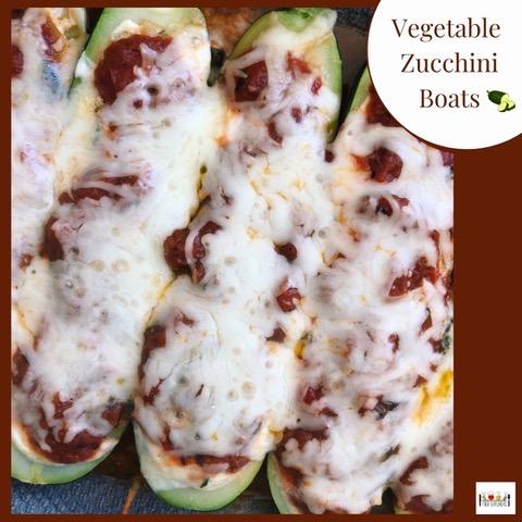 Three zucchini boats stuffed with tomato sauce and cheese