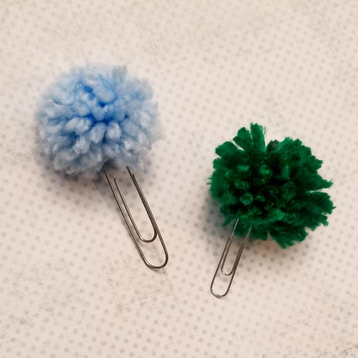 Two pom-pom bookmarks