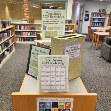 A picture of Book Bingo Cards and the submission box in the Teen Department